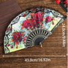 A Spanish style folding lace trim handheld fan featuring vibrant red and pink floral patterns on a light background.