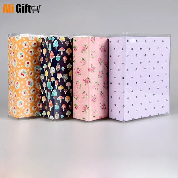 Three colorful photo cartoon memory albums in orange, dark blue, and light purple.