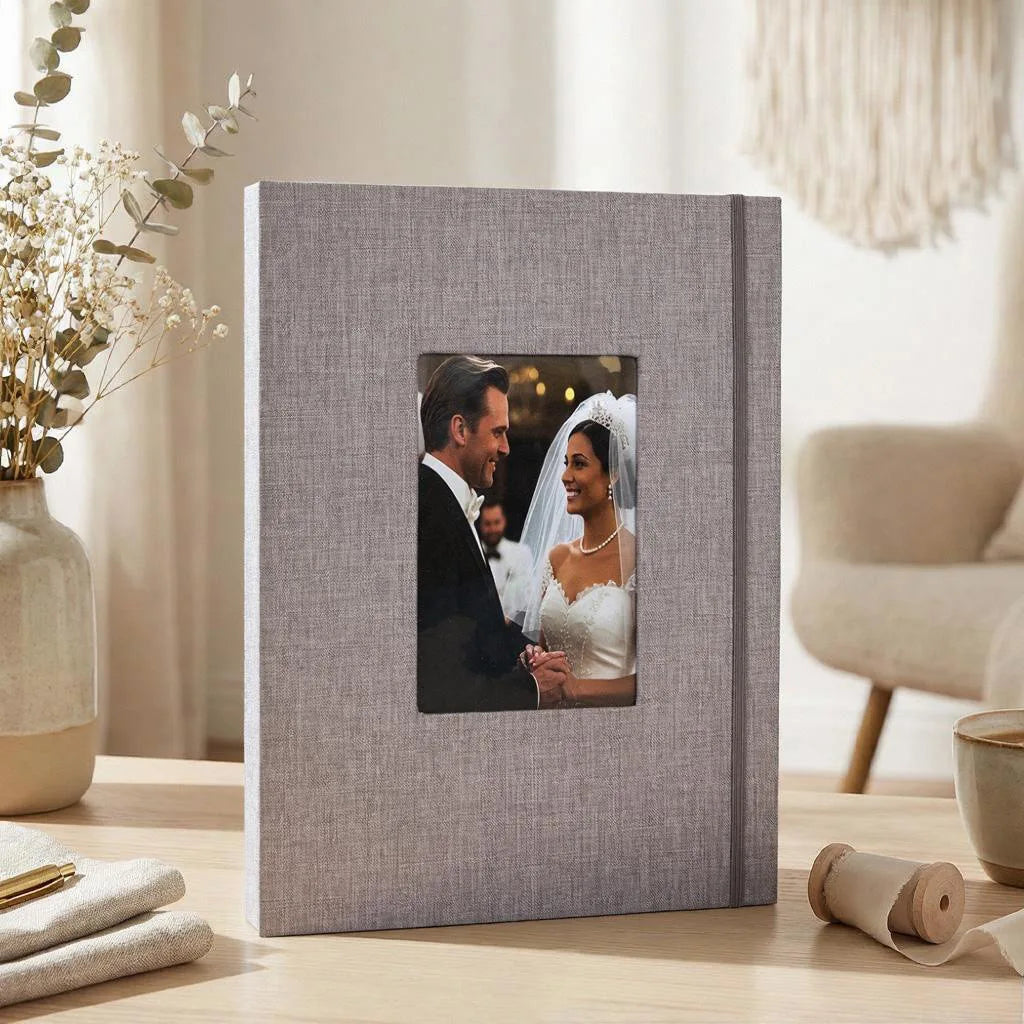 A square linen photo album with a gray cover displaying a wedding portrait of a couple.