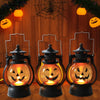 Three black pumpkin lanterns with glowing orange light and carved jack-o'-lantern faces displayed against a wooden background