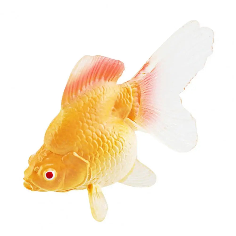 A realistic goldfish figurine with yellow body and pinkish fins against a white background.