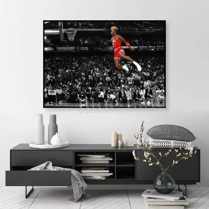 A framed canvas wall art depicting a basketball player performing a slam dunk in an arena setting.