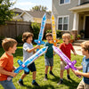 A group of children playing with inflatable pirate sword balloons in a backyard setting.