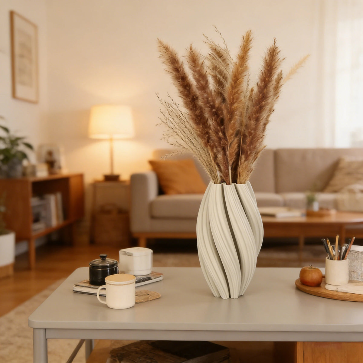 A tall vase with vertical textured waves in soft beige tones sits on a light gray table.