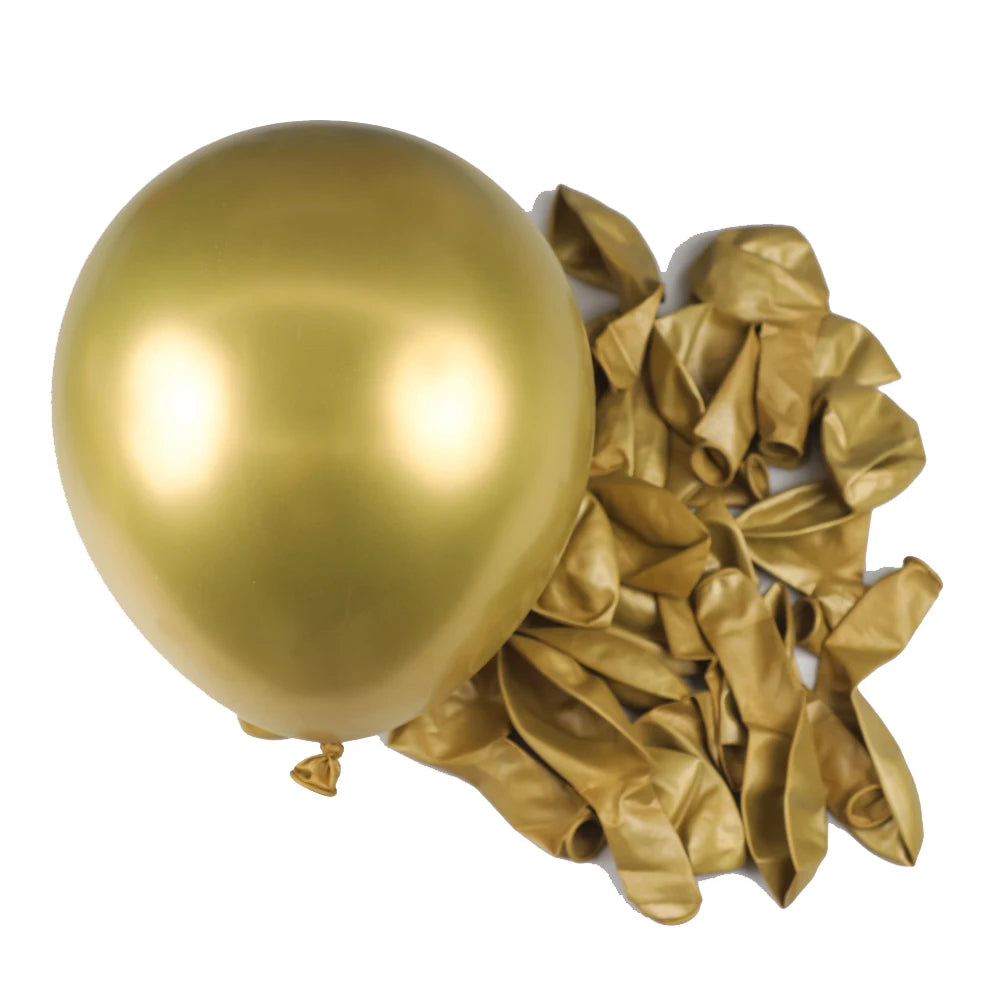 A single gold latex balloon next to a pile of crumpled gold foil streamers for party decor.