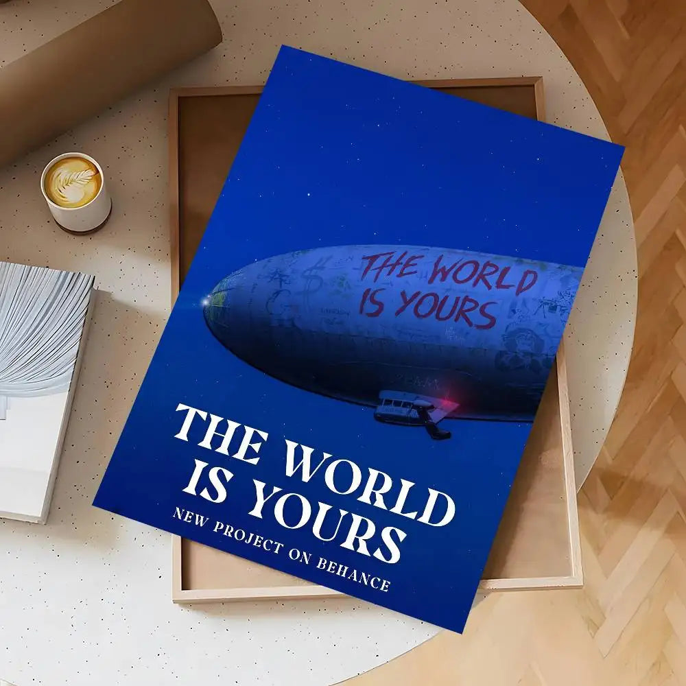 A vertical poster titled The World Is Yours featuring a blue planet against a dark background, displayed on a wooden frame.