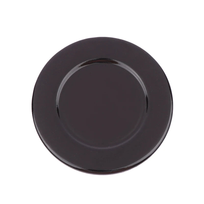 A black gas stove burner cap set with a round, flat design.