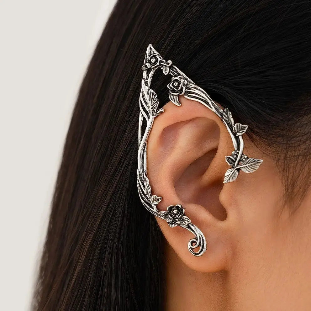 Silver elf flower leaf clip earrings worn on a woman's ear.