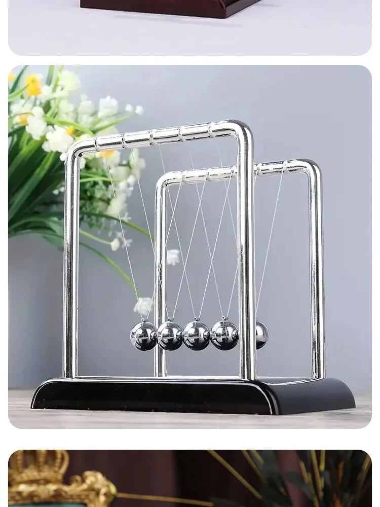 Silver Newton's cradle with balance balls on a black base for desktop decor