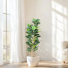A realistic artificial fiddle leaf fig tree in a white pot standing next to a window.