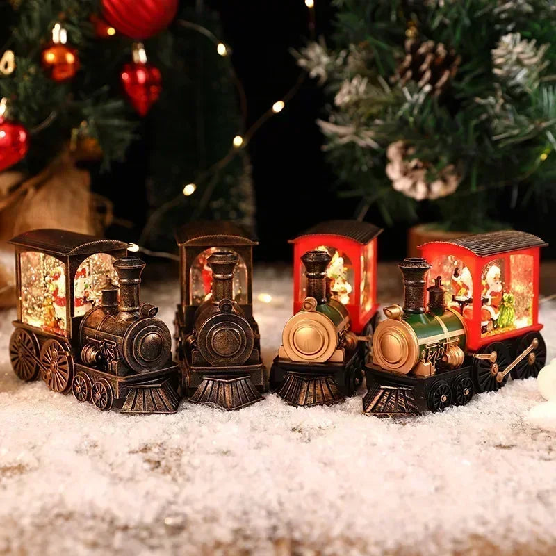 A set of miniature vintage train music boxes with LED lights and a water-filled crystal ball displayed on snow.
