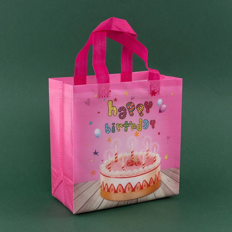 A pink reusable happy birthday gift bag with pink ribbon and a birthday cake design.