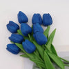 A bouquet of deep blue artificial tulips with green stems and leaves.