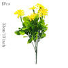 A bouquet of yellow silk daisies with green leaves for home decor
