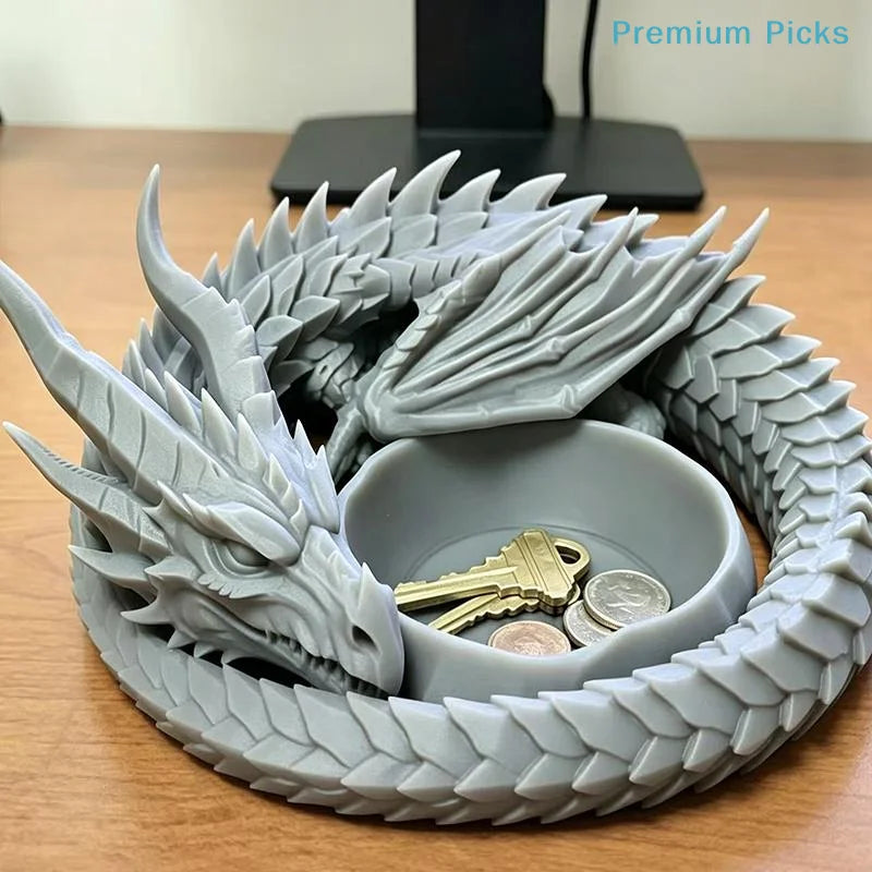 A gray dragon design decorative tray holding a gold key and silver coins.