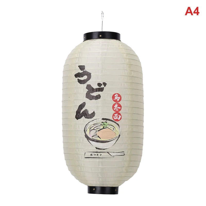 A white Japanese paper hanging lantern with black accents, featuring Japanese text and a bowl of food.