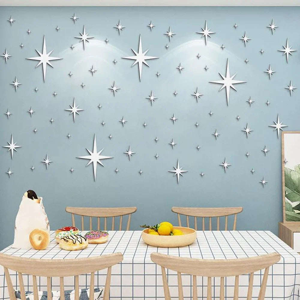 Decorative wall art featuring silver acrylic star mirror stickers on a light blue wall.