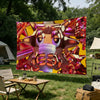 A large banner featuring a stylized, metallic, pink and gold musical instrument design hanging outdoors.