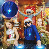 A group of children posing with LED light-up necklaces and glow in the dark lanyards in a festive setting.