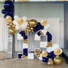 A balloon arch display featuring navy blue, gold, and white balloons arranged in a large number formation.