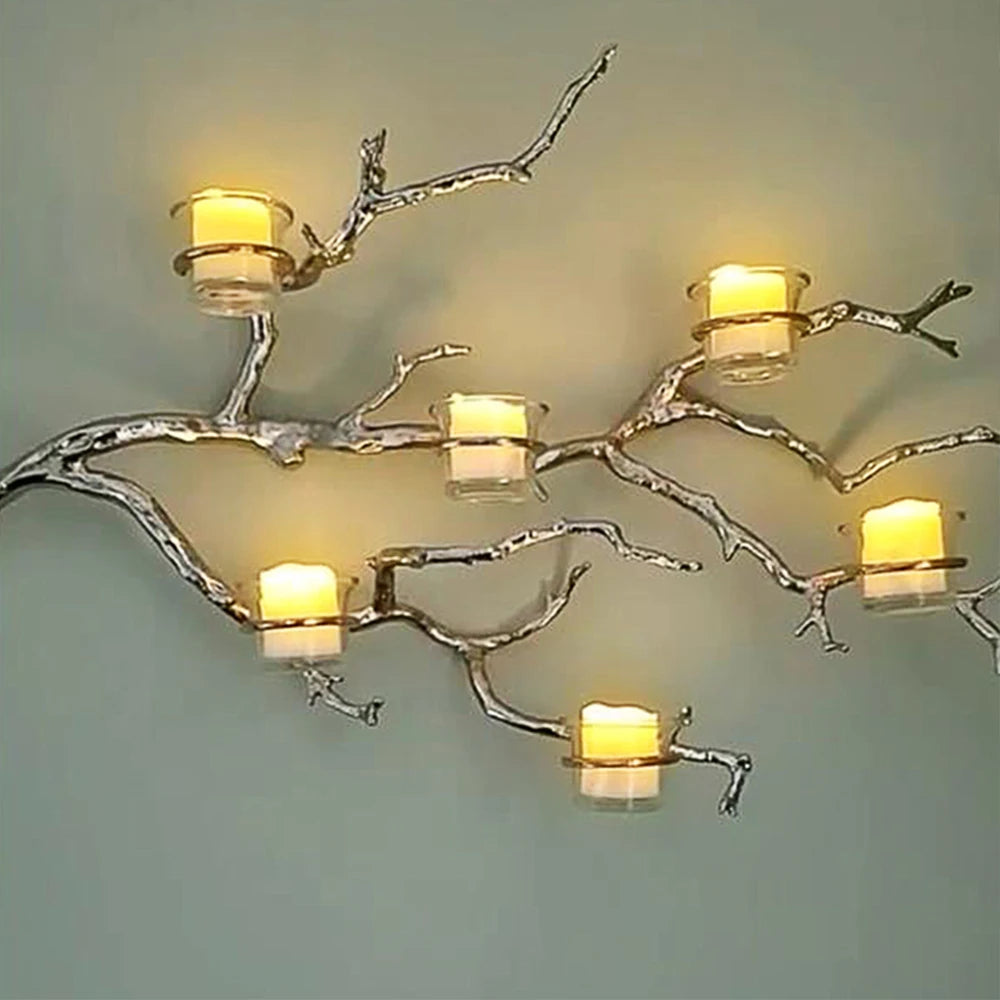 A decorative light fixture featuring branches with glowing LED tea light candles.
