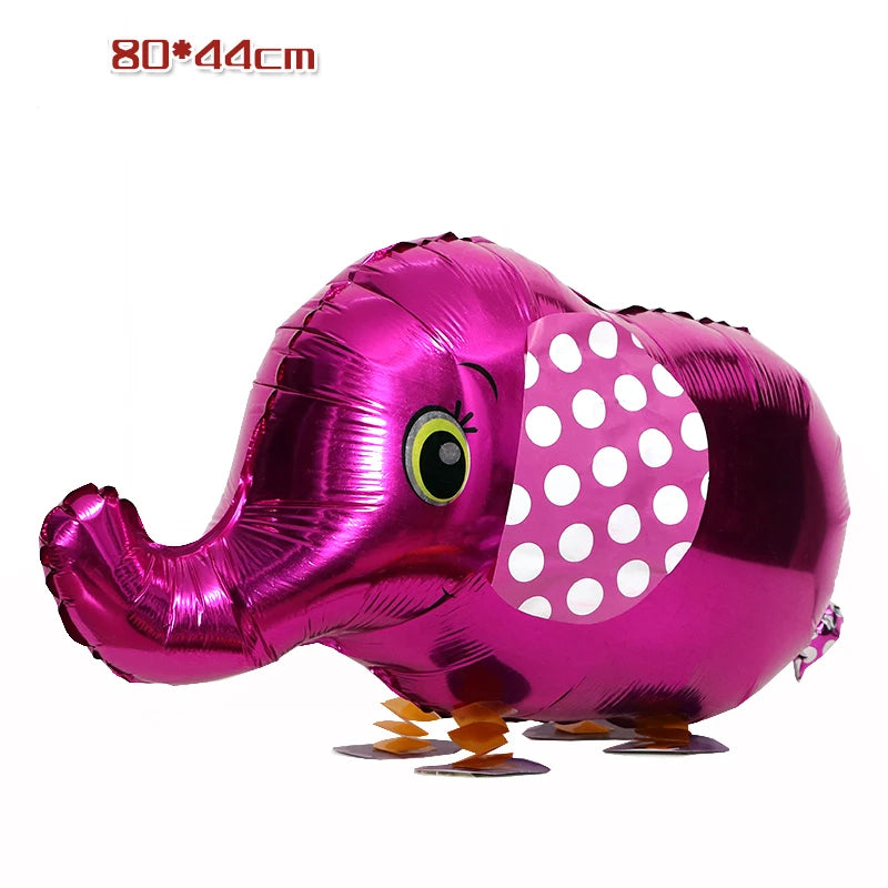 A pink elephant foil balloon with a large eye and white polka dots, used for birthday party decor.