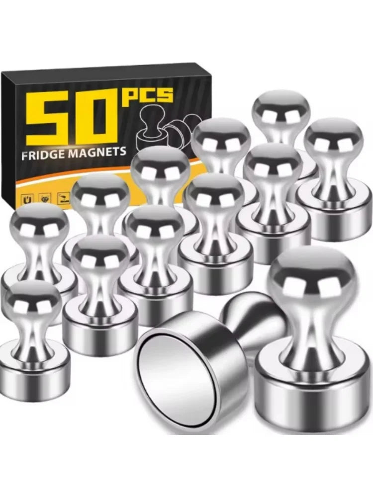A set of fifty silver magnetic fridge magnets and pushpins displayed on a black box.