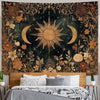 A dark tapestry featuring a vintage celestial design of a sun and moon surrounded by golden floral elements.