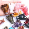 Hand-carved angel crystal figurines in various colors and shapes held in a hand.