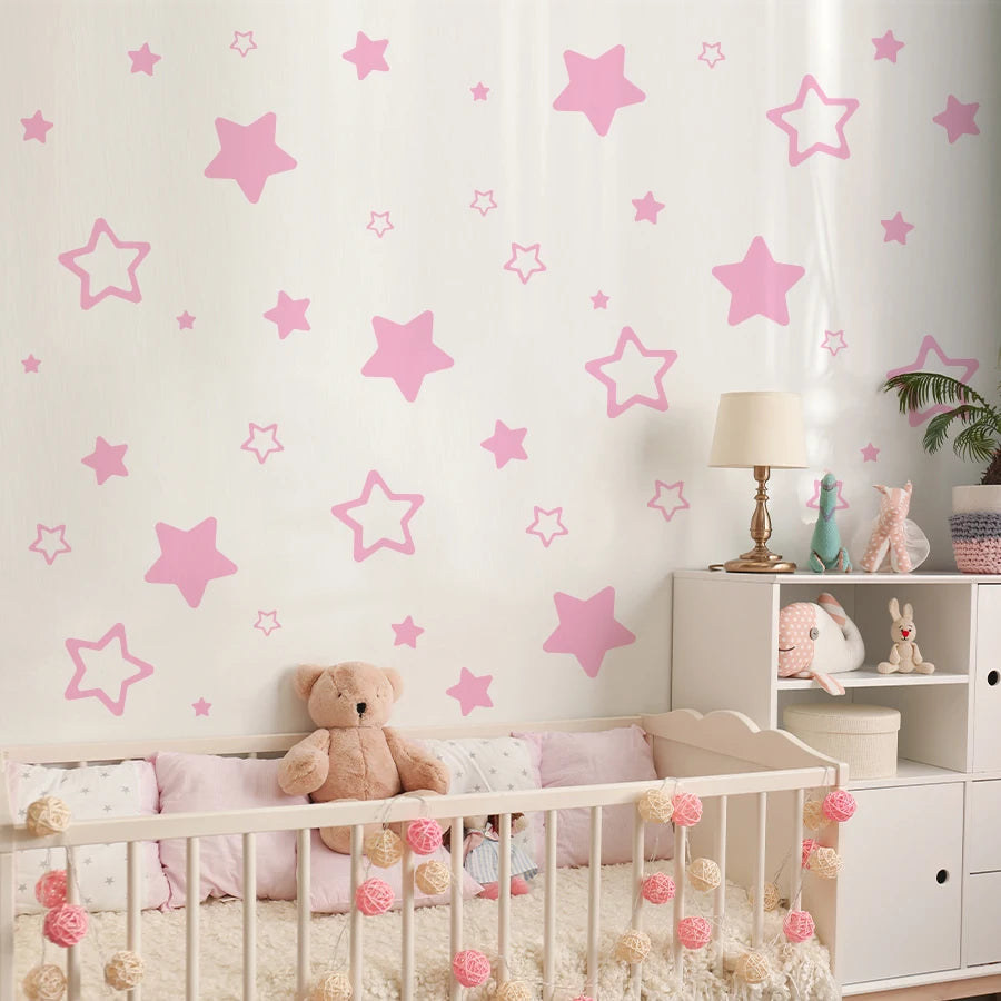 Pink star vinyl wall decal featuring various sized stars on a white wall.
