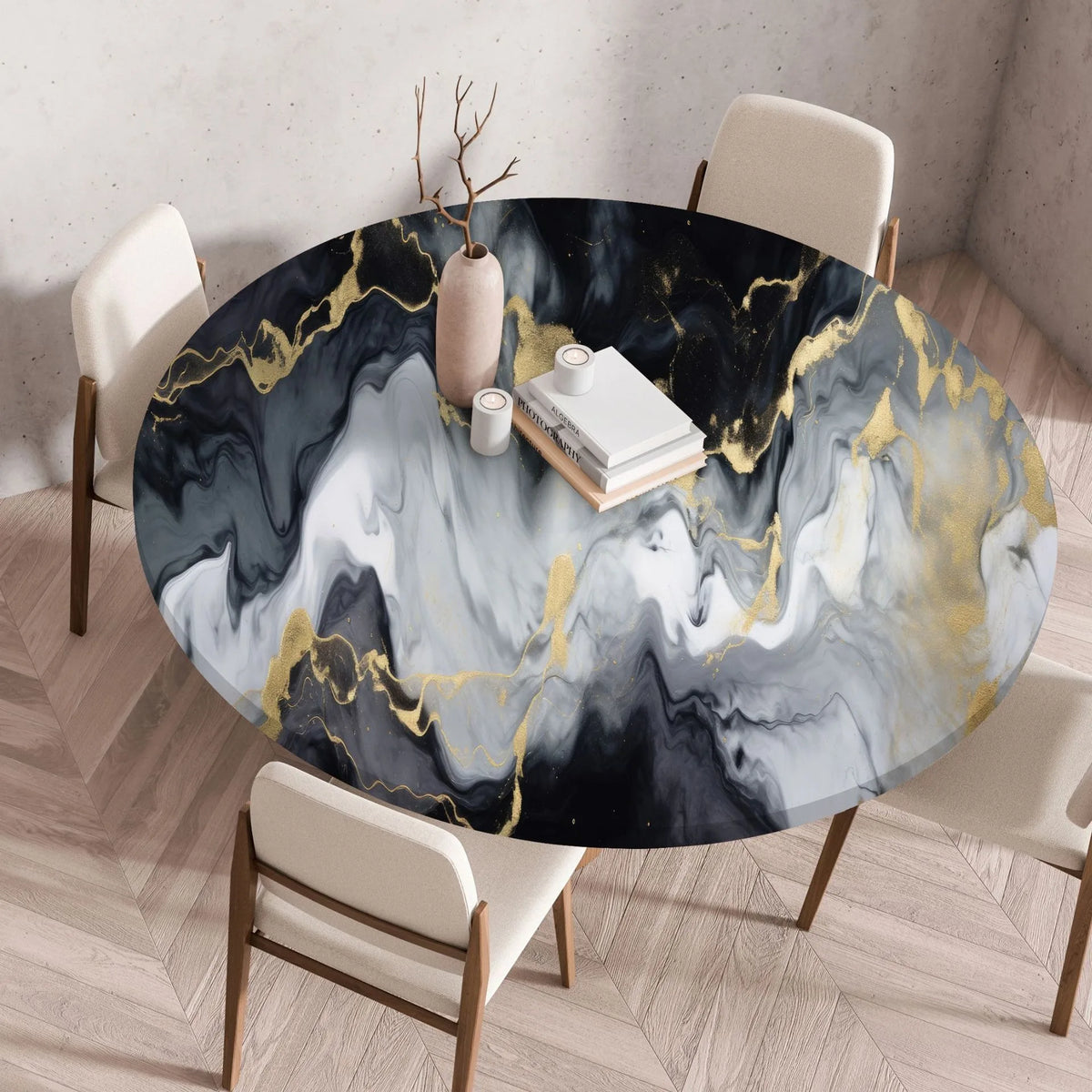 A round table covered with a marble print tablecloth featuring black, white, and gold abstract patterns.