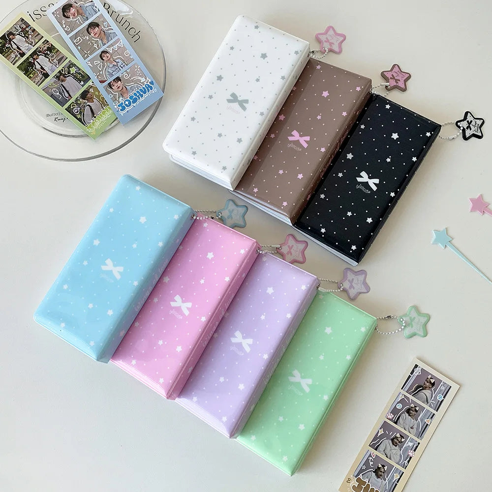 A collection of colorful photo booth albums and decorative stars arranged on a white surface.