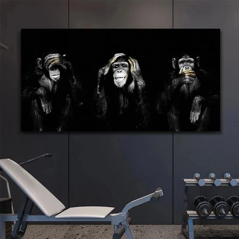 A dark canvas wall art print featuring three silhouettes of monkeys against a black background.
