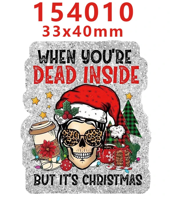 A silver glitter acrylic charm featuring a skull wearing sunglasses and a Santa hat, with Christmas greenery.