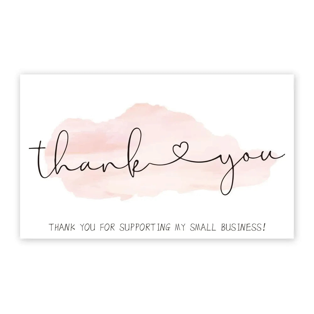 A white card with elegant black script saying thank you and a message for supporting a small business.