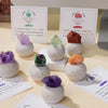 A collection of bean-shaped decorative stones in various colors including purple, green, and orange, displayed with accompany