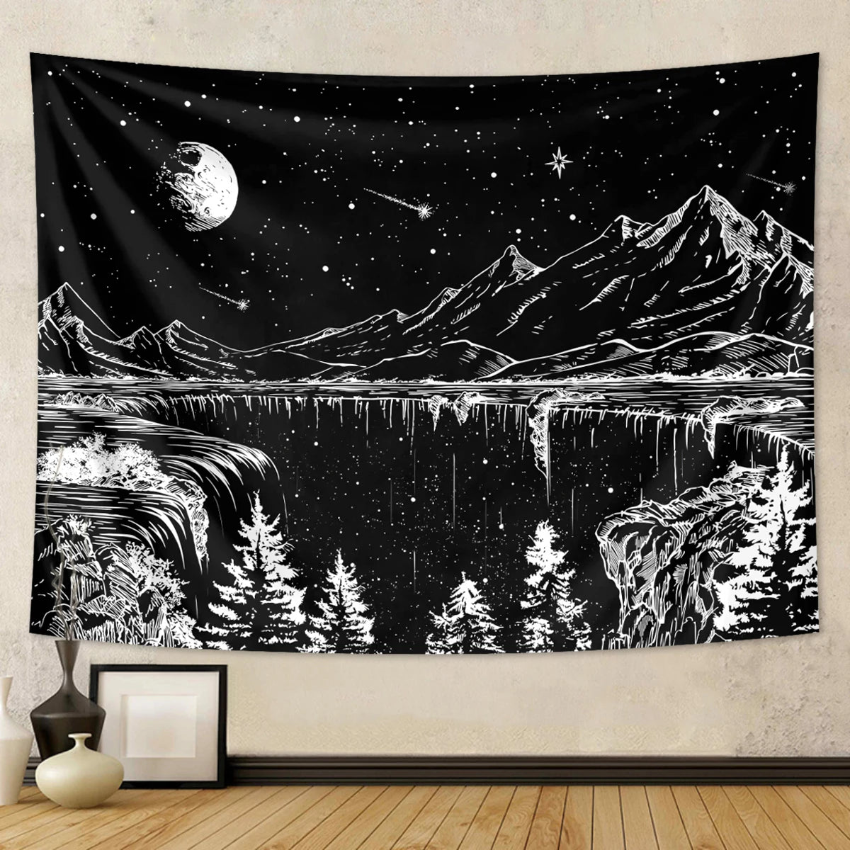A black tapestry depicting a starry night landscape with mountains, water, and trees in white and gray.