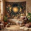 A bohemian wall hanging featuring a vintage celestial sun and moon tapestry with gold accents.