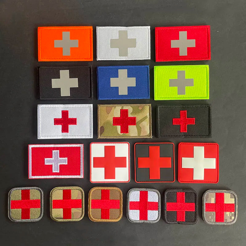 A collection of various colored and patterned medical cross patches on a dark background.