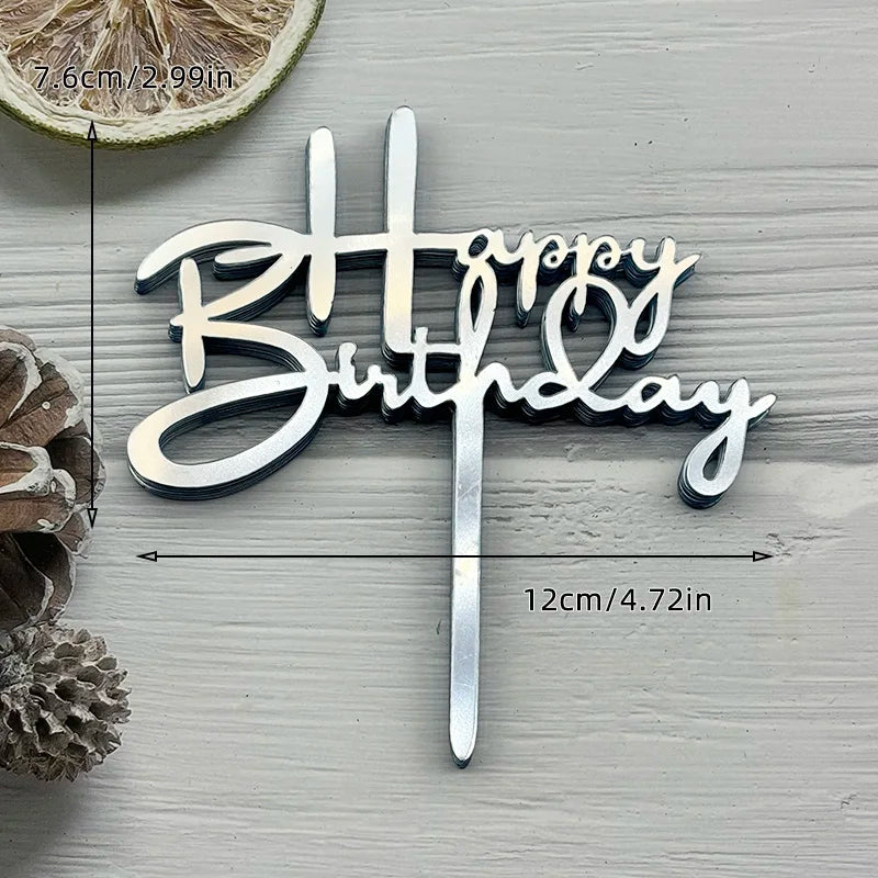 Silver acrylic birthday cake topper with the words Happy Birthday on a stick