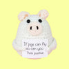 A handmade crochet pig doll with a positivity card on a light yellow background.