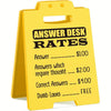 Yellow desk sign with black text listing answer desk rates such as $1.00 for an answer and $4.00 for correct answers.