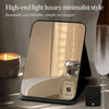 A high-end light luxury minimalist foldable vanity mirror with a glass perfume bottle displayed on a black stand.