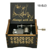 A wooden music box featuring a stylized anime character design and a metal mechanism.