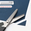 Stainless steel pinking scissors with a zig zag blade shown next to a triangle measuring tool.