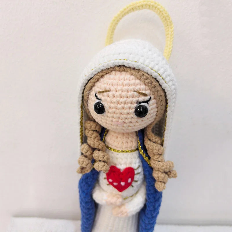 Handcrafted Virgin Mary crochet doll with a white headdress and blue garment