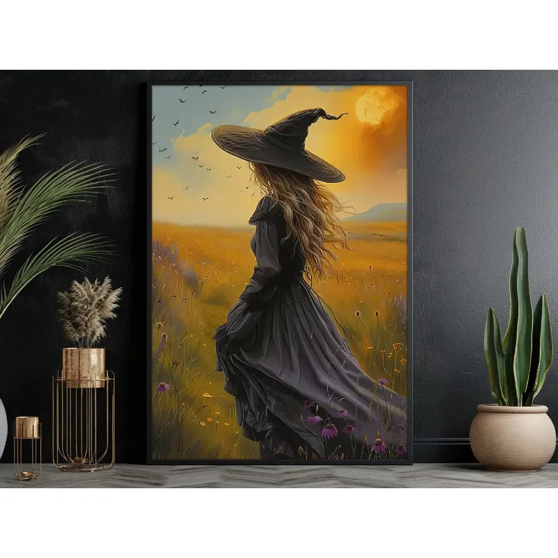 Canvas wall art depicting a dark witch with long hair wearing a wide-brimmed hat in an autumnal field.