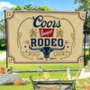 A beige banner featuring the text Coors Banquet Rodeo in dark blue and red, displayed outdoors.