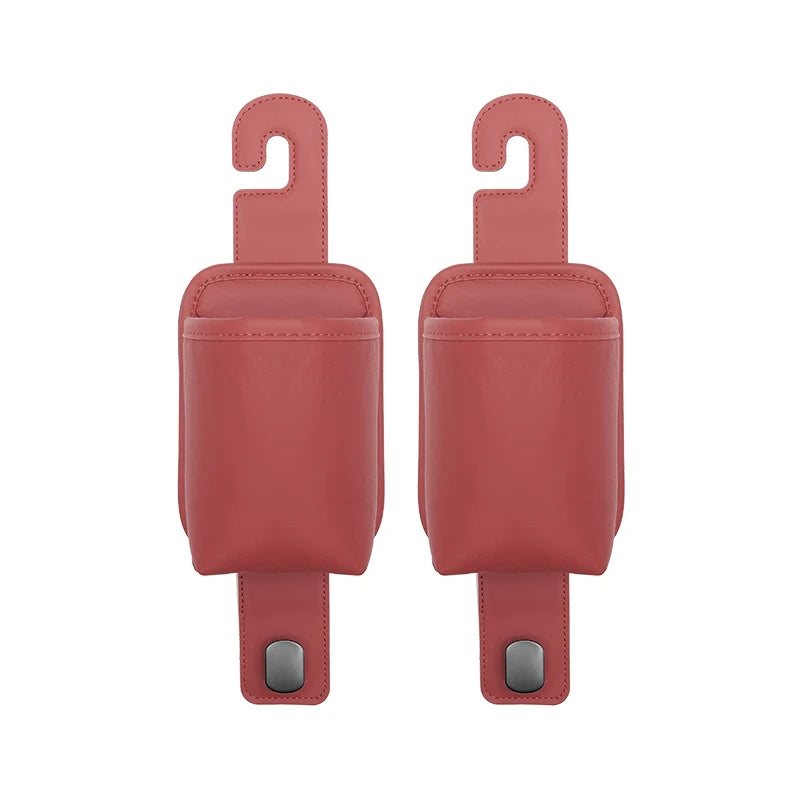 A pair of pink leather car seat back organizers with headrest hangers.