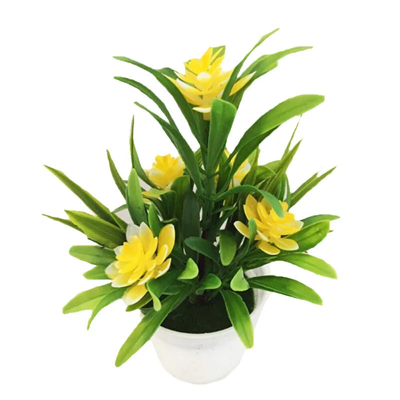 Artificial yellow lotus flowers in green leaves displayed in a white decorative pot.